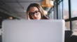 © GalakticDreamer - Bored pensive hipster girl in eyeglasses watching webinar online concentrated while sitting at university campus, tired female student studying online indoors using netbook for exam preparation