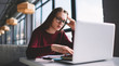 © GalakticDreamer - Pensive clever hipster girl watching webinar online via new modern laptop computer while sitting at university library, young female programmer chatting with employee using netbook application