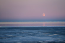 Red Moon Rising Over Pink Sky Of The Beaufort Sea At Kaktovik Alaska