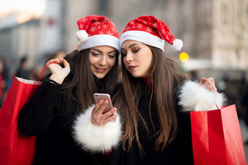 Young women in Xmas hat taking a picture together