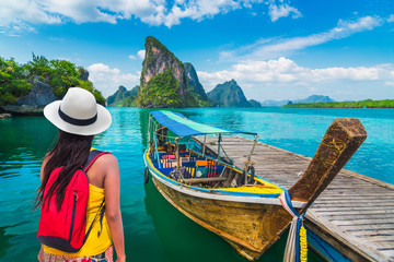 Wall Mural - Traveler woman looking beautiful destinations place, Boat for tourist on Phang-Nga bay view Panyee island scenic nature landscape, Travel adventure Phuket Thailand, Tourism Asia holidays vacation trip