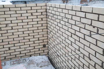  Laying bricks. Making a brick wall.Construction of a brick house.
