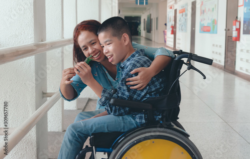 Fotomural Mother and Asian special child on wheelchair is smile happily on background in school corridor, Life in the education age of disabled children, Happy disabled kid concept
