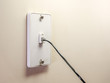 © Scott Habermann - Landline telephone wall mounted jack plate with phone cord.