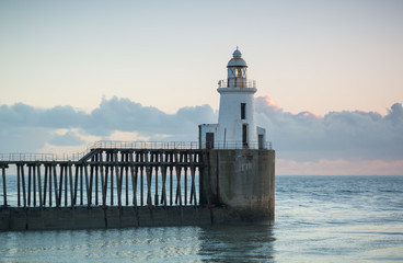 View of Blyth Harbour Piers, Blyth on the coast of Northumberland, England, UK. At sunrise on a winter morning.