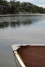 Old Pink Dinghy/rowboat On A Lake
