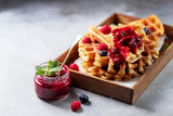 Fototapeta  - Homemade sourdough waffles with berry sauce for breakfast. The concept of proper nutrition. Selective focus, copy space.