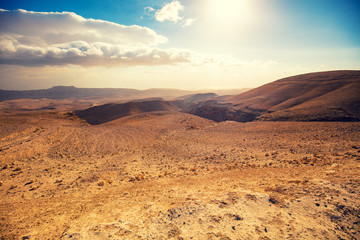 Mountainous desert with a beautiful cloudy sky. Desert in Israel at sunset