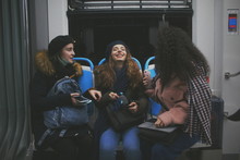 Young Women Talking, Smiling In The Subway Metro