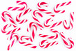 © Michal - Background made of small, white and pink candy canes, isolated on a white background.