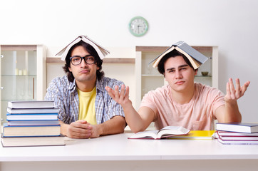 Two male students preparing for exams at home