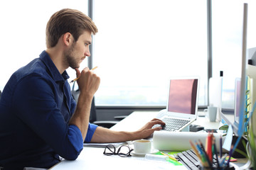 Shot of a handsome male architect working on a design in his office.