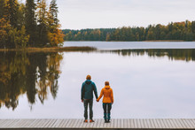Couple In Love Holding Hands Romantic Dating Family Lifestyle Relationship Man And Woman Standing On Pier Outdoor Enjoying Lake And Autumn Forest Landscape