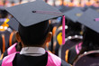 © EduLife Photos - Rear view and soft selective focus of the graduates in the graduation commencement ceremony recieving diploma degree certificate.