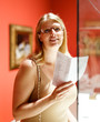 © JackF - Woman holding brochure in museum of arts