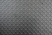 Corrugated Metal Sheet For The Floor. The Color Is Silver Gray. The Structure Of The Sheet Is Worn By Prolonged Use As Part Of The Construction Of The Pedestrian Path. Background. Texture.
