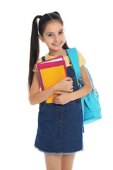 Poster - Little girl with school stationery on white background