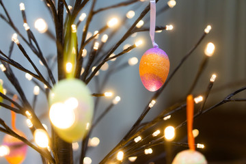 Colorful easter eggs hanging on light tree.Happy easter concept.