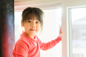 Wall Mural - Asian girl with pretty face on window background.