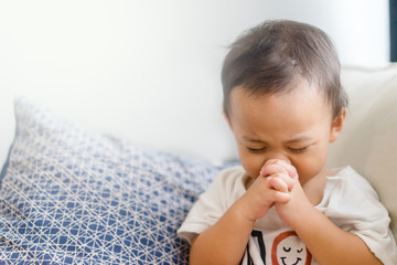 little baby boy praying in the morning at home.little boy child hand praying for thank god,hands fol