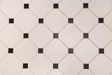 Ceramic beige octagon with tessellation black tiles background