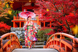 Fototapeta  - Japanese girl in kimono traditional dress walk in red bridge