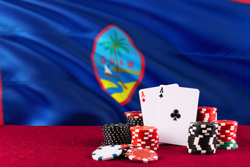 Guam casino theme. Aces in poker game, cards and chips on red table with national flag background. Gambling and betting.