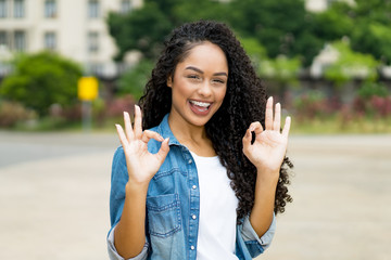 Happy brazilian girl with curly hair and braces