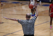 A Basketball Referee Signals A Foul