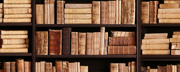 Wall Mural - antique books on old wooden shelf.