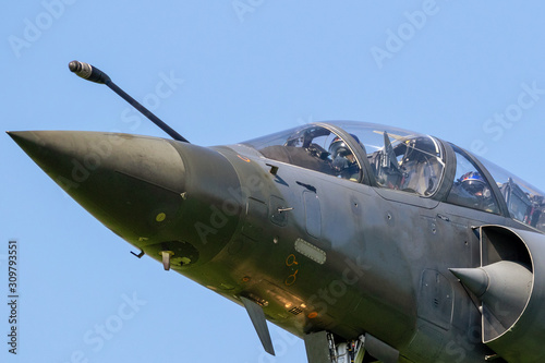 Fotografia Close up view of a modern military armed fighter jet plane taking off