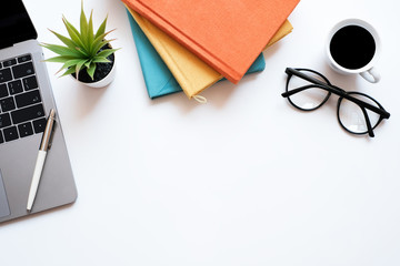 Wall Mural - Flat lay business and education concept on modern table desk background with laptop computer and stack of book, glasses and coffee cup, top view and copy space