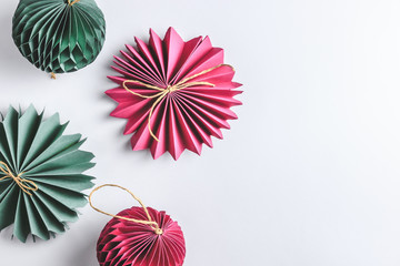 Christmas background with trendy paper decorations on white backdrop. Top view. Copy space. Flat lay