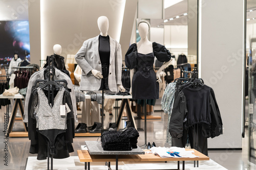 The interior of a fashion store of women\'s clothing of a famous brand. Mass market. Brand clothes. All things are laid out neatly on the shelves in the closet. Wardrobe order.