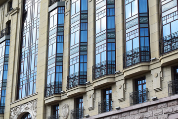 facade of a beige high-rise building with balconies