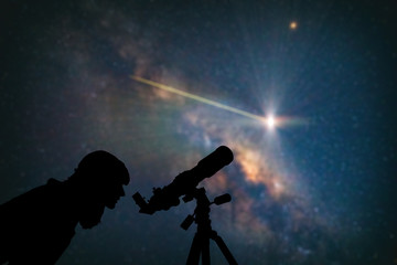 astronomer with a telescope watching at the stars and moon. my astronomy work.