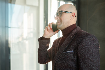 Aufkleber - Mature businessman in formalwear and eyeglasses talking by mobile phone