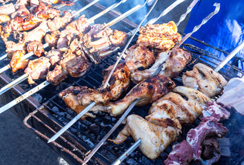 Grilled kebab cooking on metal skewers