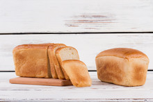 Sliced And Whole Bread On Wooden Background. White Bread Loaves. Space For Text.