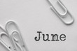White plastic paper clips with June word