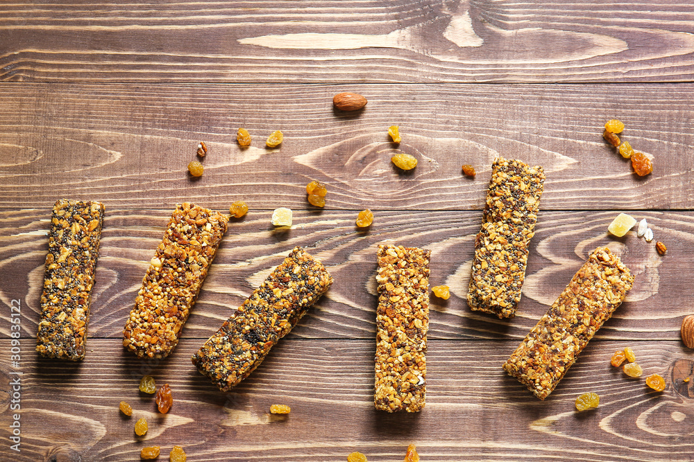 Tasty granola bars on wooden table