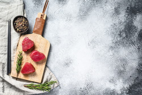 Fotomural Raw red tuna steak. Gray background. Top view. Space for text