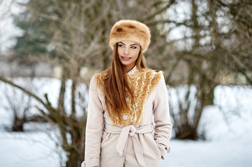 Wall Mural - Beautiful woman walking in winter park