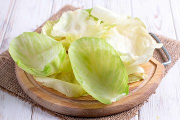 Wall Mural - Ingredients for cooking cabbage rolls. Cabbage leaves on a cutting board