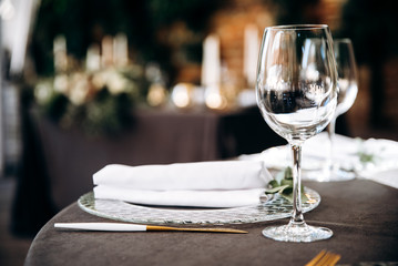 Glass for the wine on the festive table, close-up. Bokeh