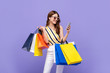© Atstock Productions - Beautiful Asian woman carrying colorful bags shopping online with mobile phone