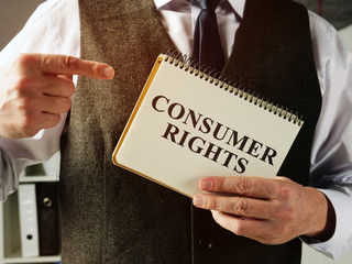 Businessman with consumer rights law in the hands.