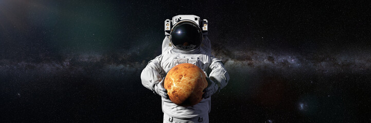 Wall Mural - astronaut holding planet venus, world of the solar system