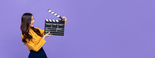 Young Beautiful Asian Girl Holding Movie Clapperboard