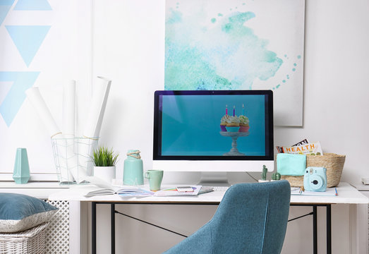 Comfortable designer's workplace with modern computer in studio